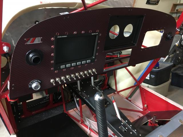 Instrument panel fitting with EXP Bus, Dynon D180, and FlyPad iPad mount installed. Control stick with carbon fiber grip and elevator trim switch fitting.