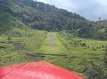 Short final at Okbab with a crosswind (the windsock is at the bottom left side of the strip). This is a challenging airstrip; touchdown is 11% slope...